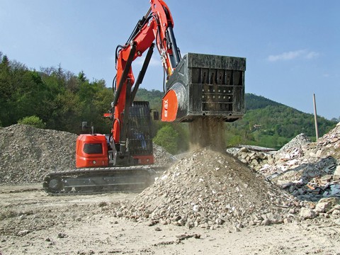 crusher bucket in use on the end of an excavator