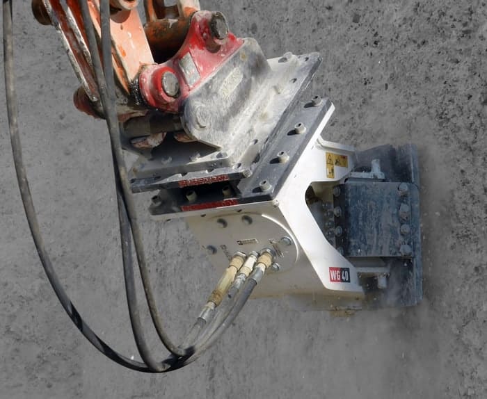 Road planer in use on a wall